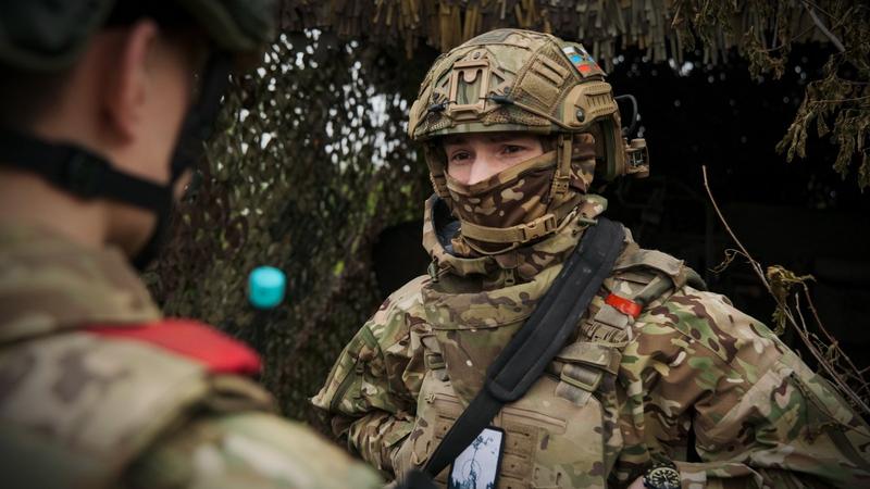 Russian soldiers talk to each other near their position in an undisclosed location in Ukraine. 