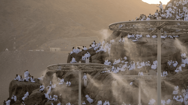 Water mist is sprayed on Muslim pilgrims as they pray on the rocky hill known as the Mountain of Mercy, on the Plain of Arafat, during the annual Hajj pilgrimage, near the holy city of Mecca on June 27, 2023. 