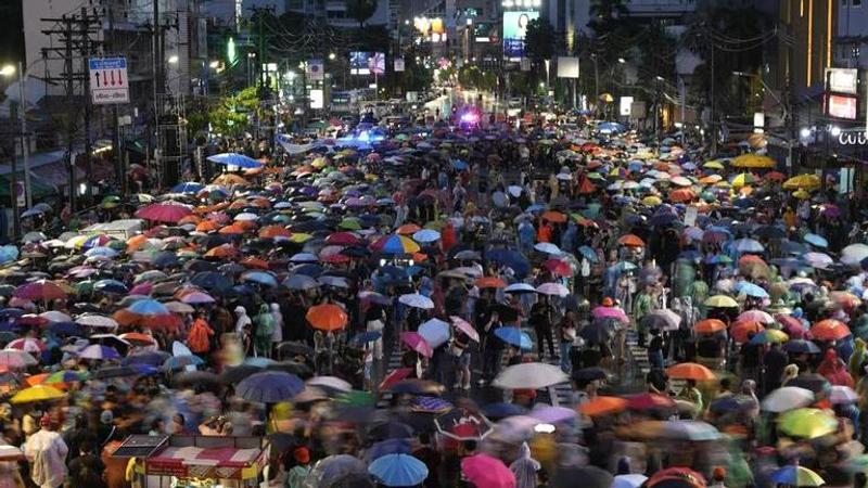 Supporters of the Move Forward Party walk in a circle during a protest in Bangkok