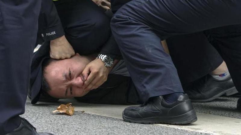 Chinese force tackles a protestor